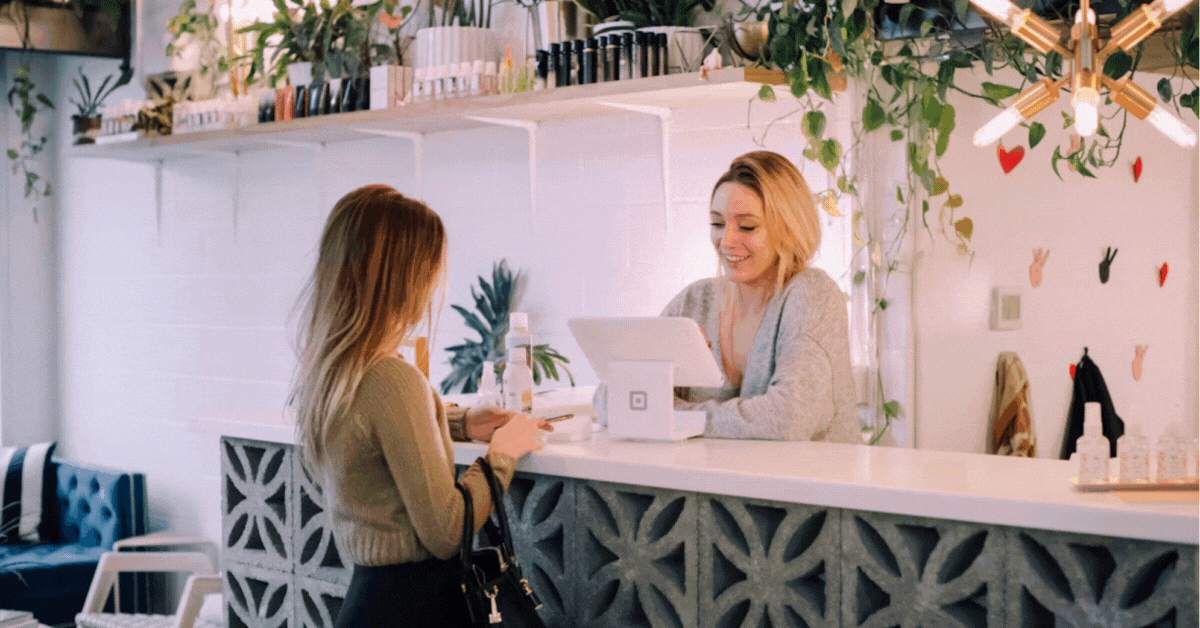 Café staff serving a customer with a TablePanel tablet POS terminal